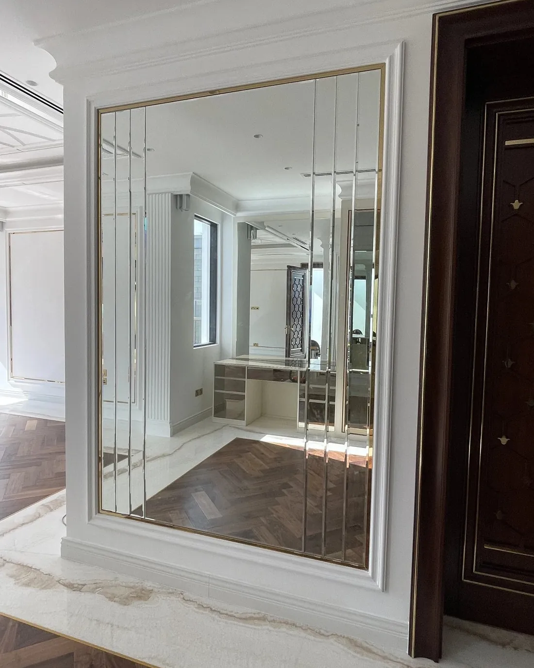 Layered gold-framed mirrors