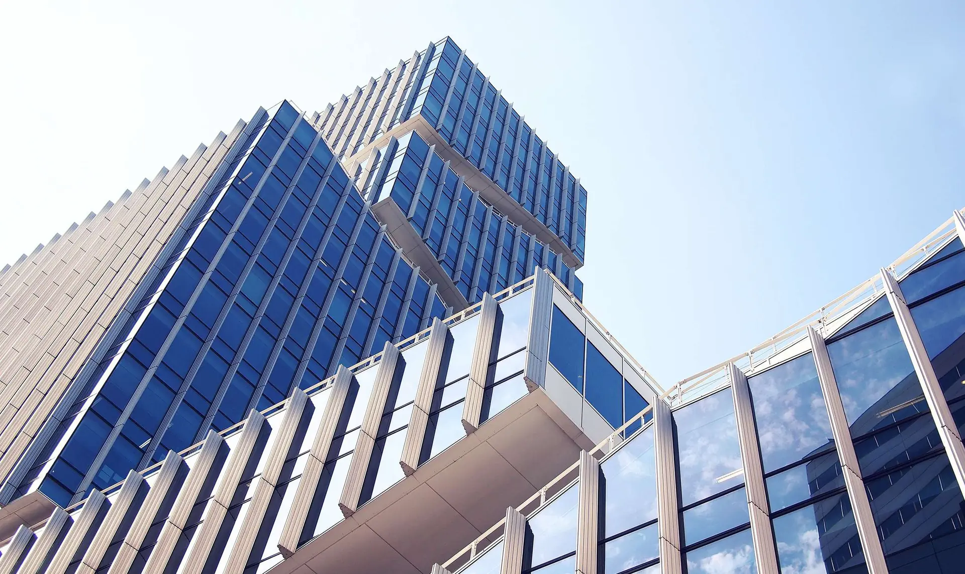 Glass curtain-wall tower against a clear sky